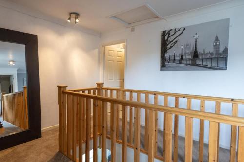 a staircase in a house with a picture on the wall at King Coel in Colchester
