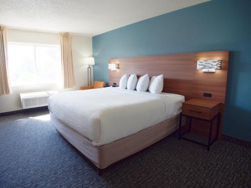 a hotel room with a large bed and a window at Ramada by Wyndham Coeur d'Alene in Coeur d'Alene