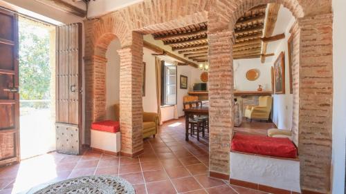 a living room with brick walls and a dining room at Cortijo San Rafael Constantina by Ruralidays in Constantina