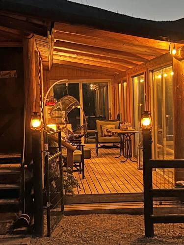a large wooden deck with a table and chairs at Cozy Cabin Oxen-Le-Fields Montana in Conner