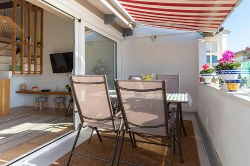 a small balcony with two chairs and a table at Loft con amplia terraza en el centro de Santander in Santander