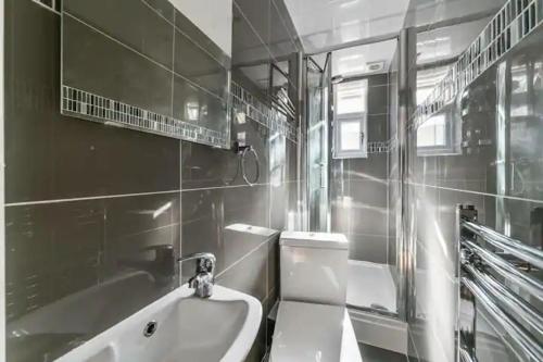 a bathroom with a sink and a toilet at Amazing 4 bed house in Kingston in Kingston upon Thames