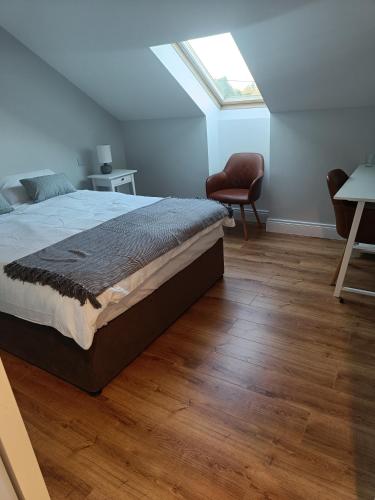a bedroom with a bed and a skylight at Drumquin Accommodation in Ennis