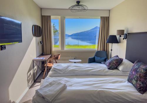 a hotel room with two beds and a large window at Sirdalsvatnet Hotel in Sirdal in Tonstad