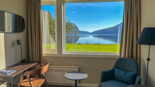 a room with a window with a view of a lake at Sirdalsvatnet Hotel in Sirdal in Tonstad