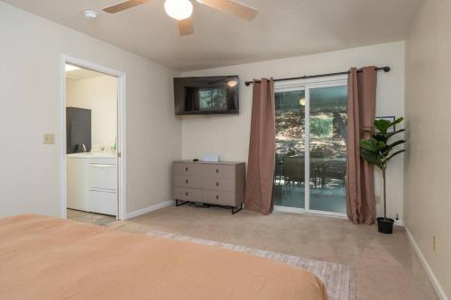 a bedroom with a bed and a sliding glass door at Bald Bear Barracks in Mariposa