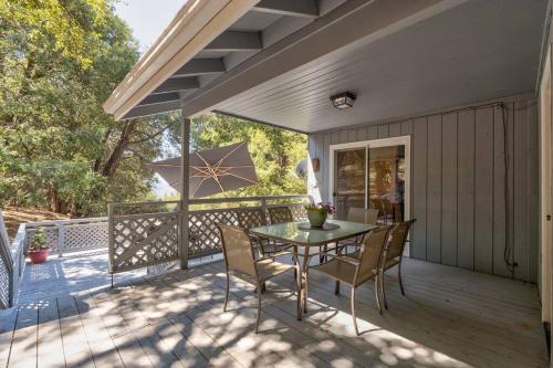 a patio with a table and chairs on a deck at Bald Bear Barracks in Mariposa