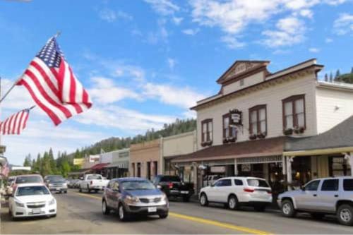 a street in a town with cars and an american flag at Bald Bear Barracks in Mariposa