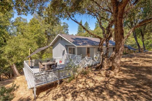 a white house with a tree in front of it at Bald Bear Barracks in Mariposa