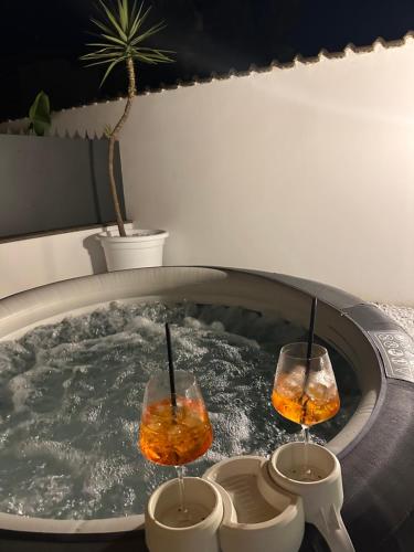 two wine glasses sitting in a hot tub at VILLA SEASIDE HAVEN - Private Retreat with Garden in Anzio in Anzio
