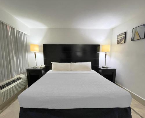 a bedroom with a large bed with two night stands at Wyndham Garden Los Mochis Plaza Inn in Los Mochis