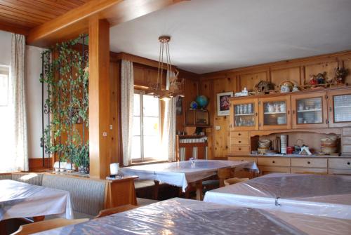 a kitchen with wooden walls and tables and a window at Binterhof in Sesto