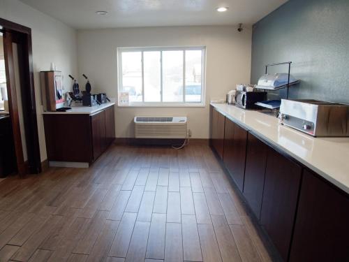 a large kitchen with a counter and a window at Ramada by Wyndham Coeur d'Alene in Coeur d'Alene