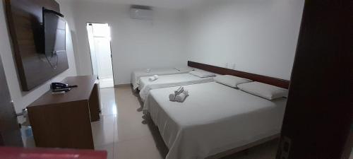 Ένα ή περισσότερα κρεβάτια σε δωμάτιο στο Hotel terceiro milênio 1