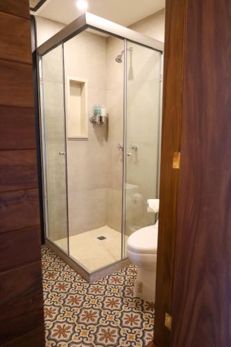 a glass shower in a bathroom with a toilet at CASA SAUTO11 Mexican architecture and design suite in Mexico City