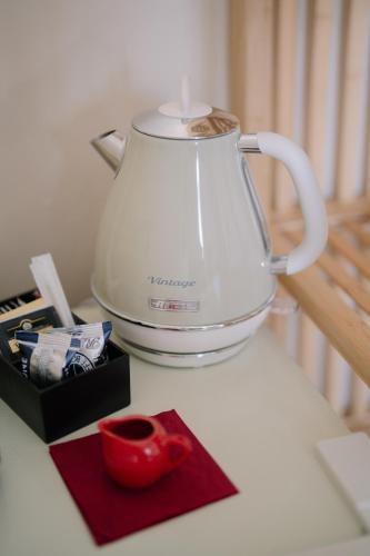 a blender sitting on top of a counter with a cup at Taga Suites in Catania