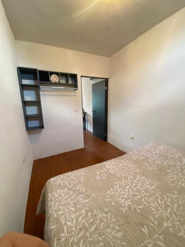 a bedroom with a bed and a room with a window at Departamento acogedor segundo piso 2 recamaras in Monterrey