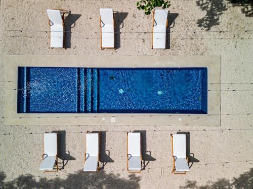 an overhead view of a swimming pool with chairs at Modern Villas in Tropical Community by Tamarindo in Villarreal