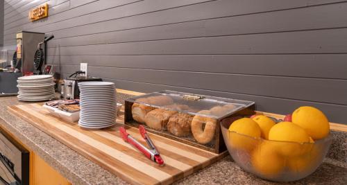 a counter with a cutting board with bread and eggs at Prestige Oceanview Hotel Prince Rupert in Prince Rupert