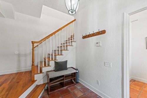a stairway with a chair and a stair case at Dolphin Cove Waterfront Home with Dock in Saint Augustine