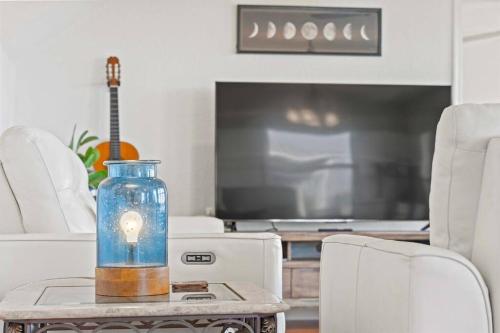 a glass jar with a light in it on a table at Dolphin Cove Waterfront Home with Dock in Saint Augustine