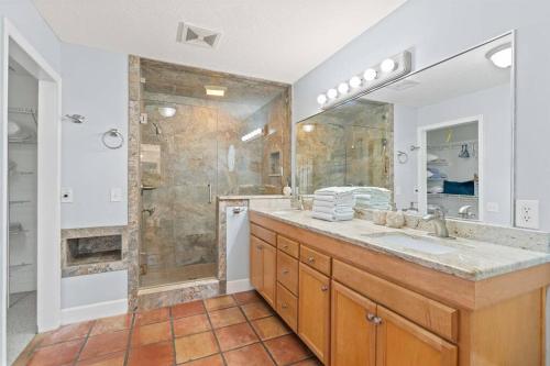 a bathroom with a shower and a large sink at Dolphin Cove Waterfront Home with Dock in Saint Augustine
