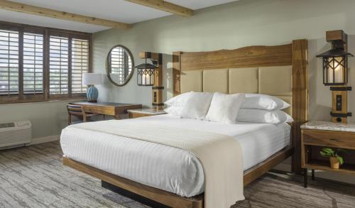a bedroom with a large bed and a desk at High Peaks Resort in Lake Placid