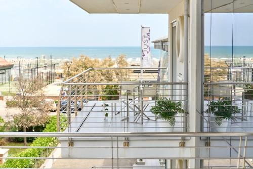 a balcony with a view of the beach at JUST SUITES in Cervia