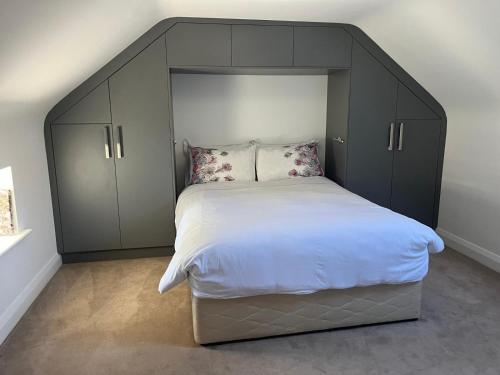 a bedroom with a large bed with a black headboard at Chestnut Lodge Ballindrum R14YW02 in Athy