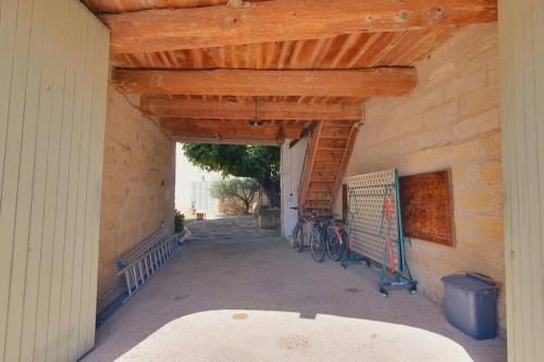 a garage with two bikes parked in a building at Maison de Village en Camargue Parking Clim Wifi - ROSSIconciergerie - Linge inclus in Saint-Laurent-dʼAigouze