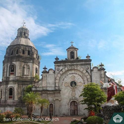 an old church with a woman standing in front of it at New Cozy Studio Unit in Azure North Pampanga with Pool View in Lagundi