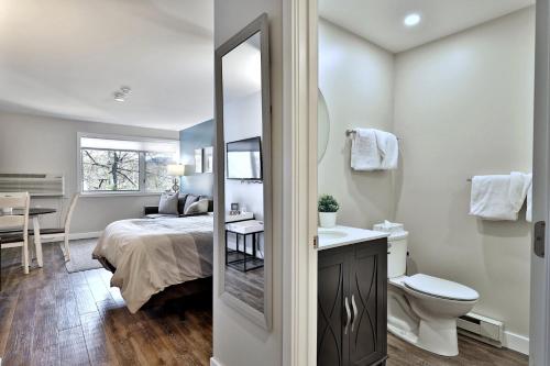 a bedroom with a bed and a bathroom with a mirror at Charming Killington Center Studio Condo #341 on the Bus Route - Summer Pool in Killington