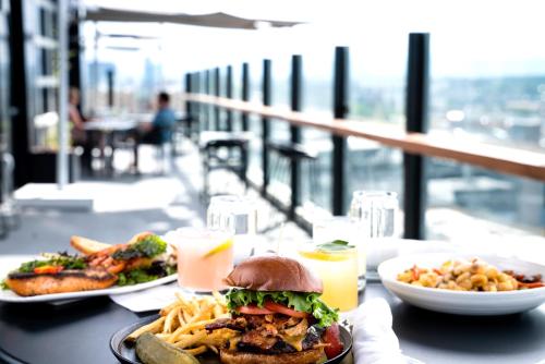 a table with two plates of food and a sandwich and fries at The Source Hotel in Denver