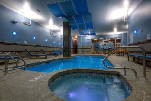 a large swimming pool in a building with a pool at Holiday Inn Saskatoon Downtown by IHG in Saskatoon