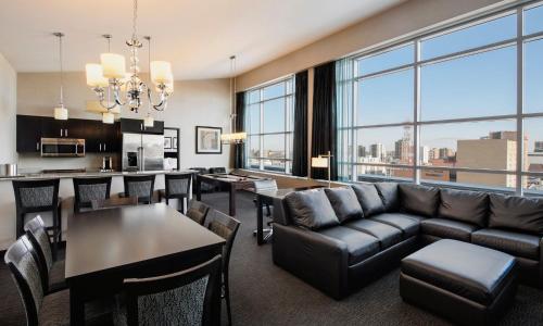 a living room with a couch and a table at Holiday Inn Saskatoon Downtown by IHG in Saskatoon