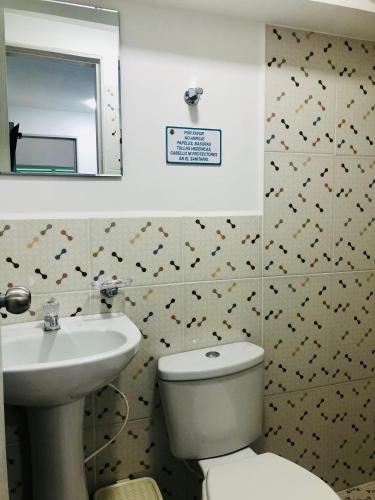 a bathroom with a toilet and a sink and a mirror at Hotel Café Color in Armenia