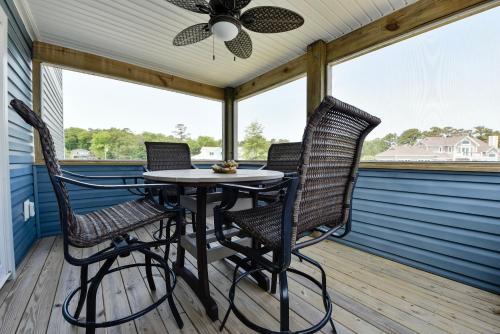 a screened porch with a table and two chairs at Canalfront, Private Pool, Sound Views, COL22, Island Breeze in Kill Devil Hills