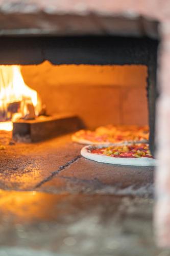 a pizza is coming out of an oven at Hotel Dubrovnik in Marktoberdorf