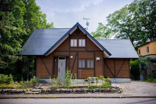 a wooden house with a black roof at Pets allowed, natural hot spring rental villa "Yuy - Vacation STAY 54103v in To-katta