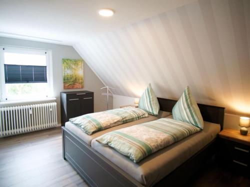 a bed with two pillows on it in a room at Classy apartment in Bad Sachsa in Bad Sachsa