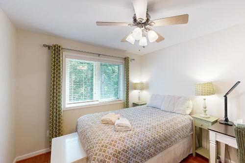 a bedroom with a bed and a ceiling fan at Turtle Cove in Glenora