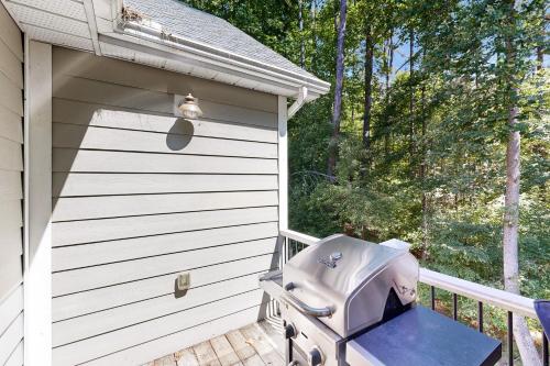 a grill sitting on a deck next to a shed at Turtle Cove in Glenora
