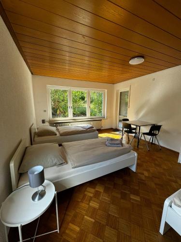a bedroom with a large bed and a wooden ceiling at A&D Monteurzimmer Ferienwohnung in Bad Mergentheim