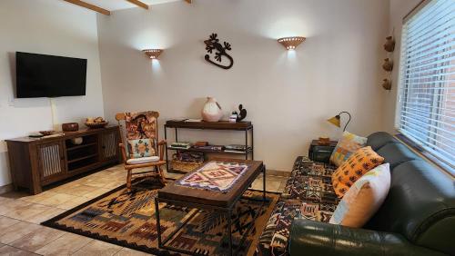 a living room with a couch and a tv at Golf course condo in Moab in Moab
