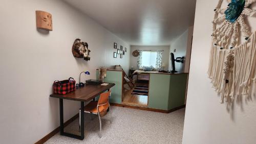 a room with a desk and a room with a hallway at Golf course condo in Moab in Moab