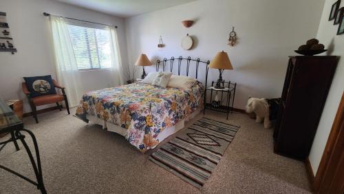 a bedroom with a bed and a dog in it at Golf course condo in Moab in Moab