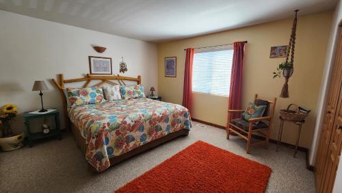 a bedroom with a bed and a red rug at Golf course condo in Moab in Moab