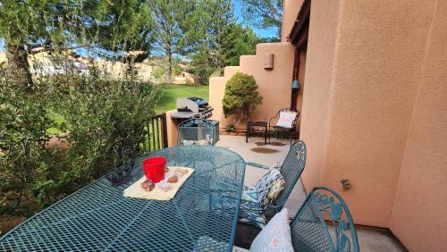 a blue table with a cup on it on a patio at Golf course condo in Moab in Moab