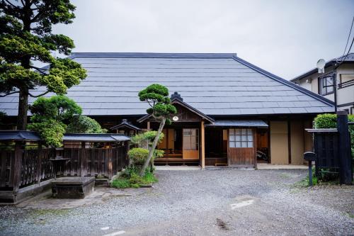 a japanese house with a tree in front of it at Muratamachi bukeyashiki- Gaia Resort - Vacation STAY 54893v in Murata