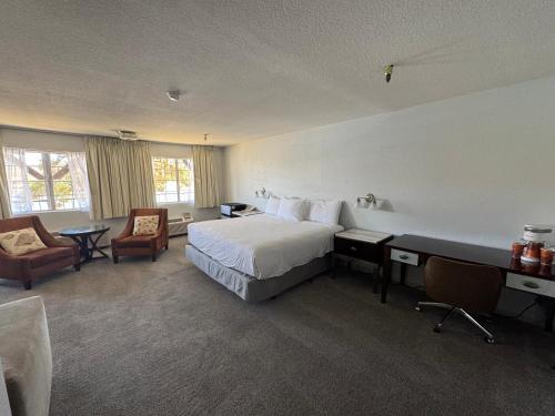 a hotel room with a bed and a desk at The New Pioneer in Laughlin